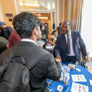 Job seeker shaking hands with employer at Meet Boston's annual Career Fair