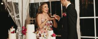 a bride and groom enjoying their wedding cake