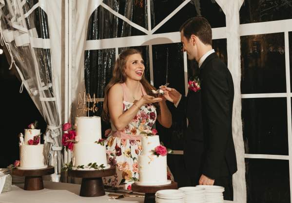 a bride and groom enjoying their wedding cake