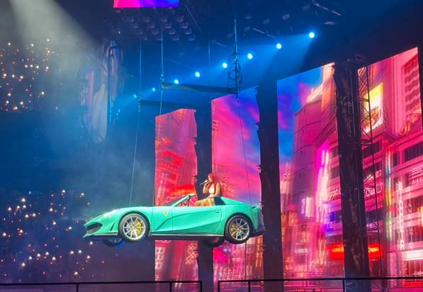 Karol G floating in a car during her performance in TD Garden