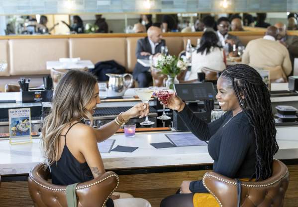 Two people grabbing drinks at The Pearl