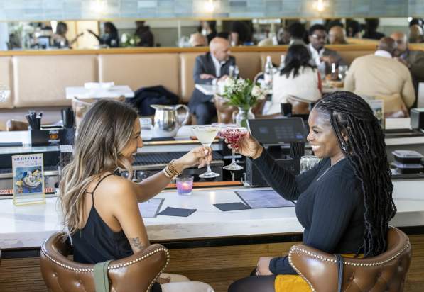 Two people grabbing drinks at The Pearl