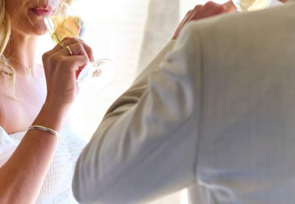 couple enjoying a glass of champagne in their hotel room